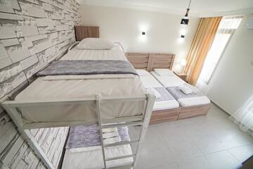 Фото номера Семейный номер с балконом Гостевой дом Guest House Holiday Village г. Батуми 12
